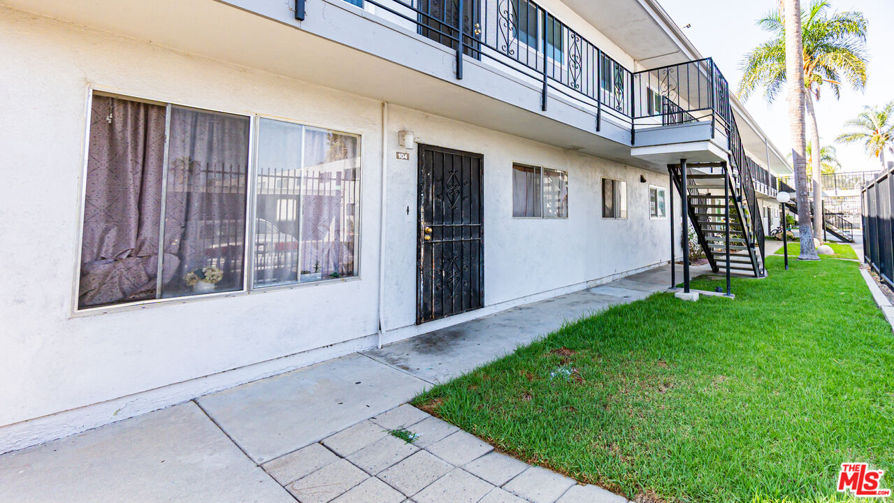 5500 Ackerfield Avenue, Unit 104 Long Beach, CA 90805 - Photo 4 of 19 a view of front door of house with yard