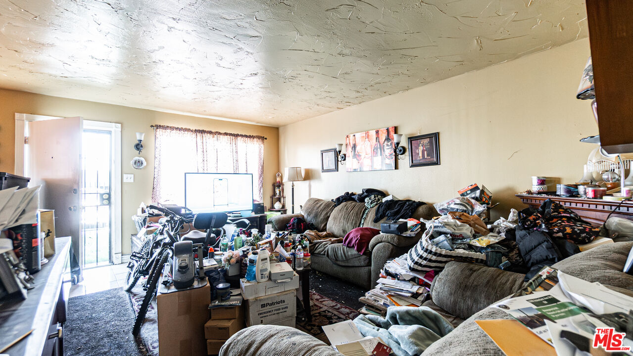 5500 Ackerfield Avenue, Unit 104 Long Beach, CA 90805 - Photo 5 of 19 a living room with furniture a fireplace and a window