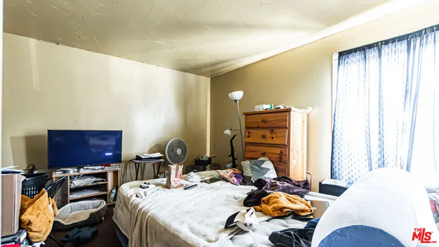 a bedroom with furniture and a window