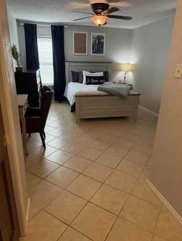a bedroom with furniture and a potted plant