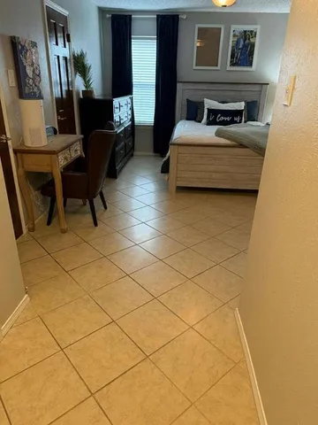 a bedroom with a bed and a table in it