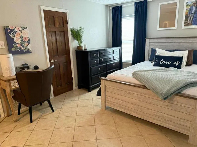 a bedroom with a bed and a window