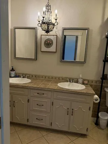 a bathroom with a sink toilet and mirror