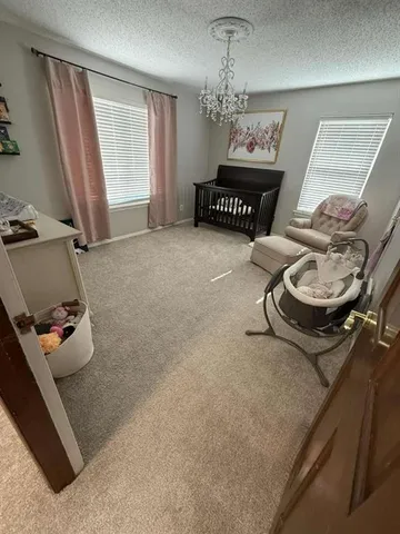 a bedroom with a bed and a flat tv screen