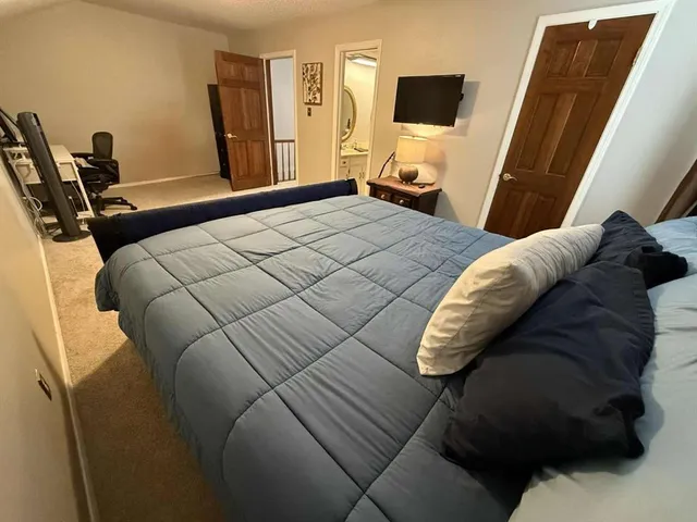 a bathroom with a granite countertop double vanity and a mirror