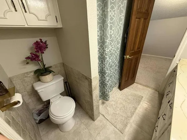 a view of house with outdoor seating and covered with wooden fence