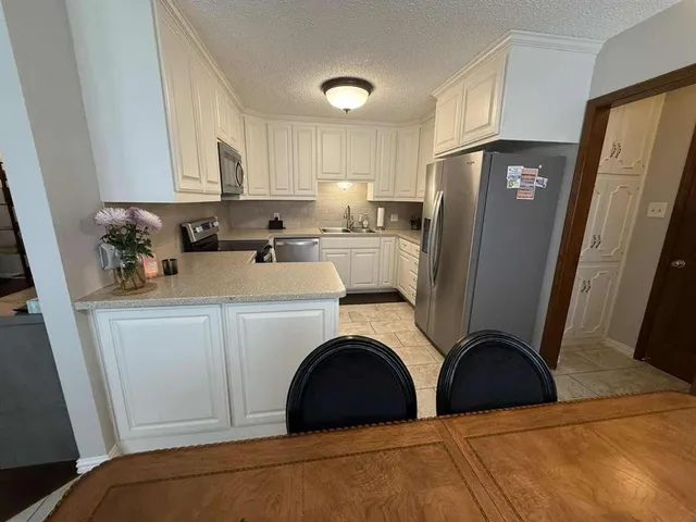 a kitchen with a sink a stove and cabinets