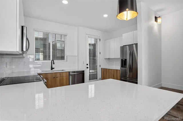 a kitchen with stainless steel appliances a stove a sink and a microwave