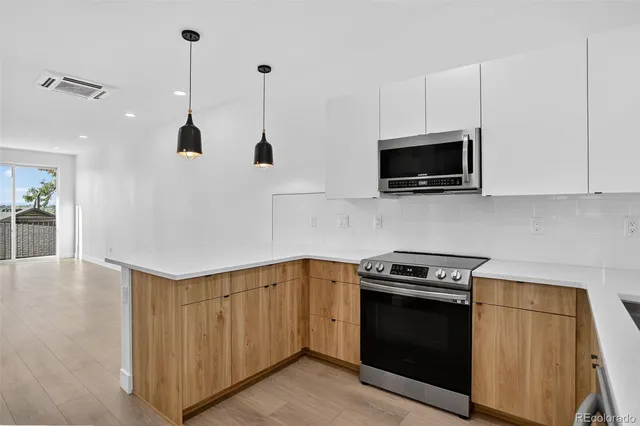 a kitchen with stainless steel appliances a refrigerator and a counter space