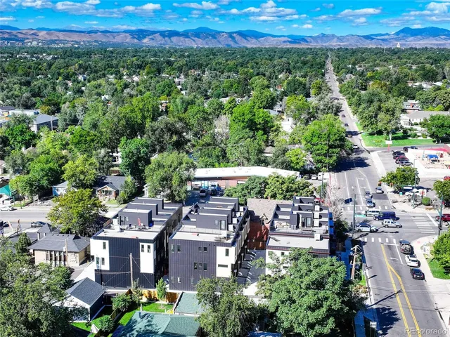 an aerial view of a house with a yard basket ball court and outdoor seating
