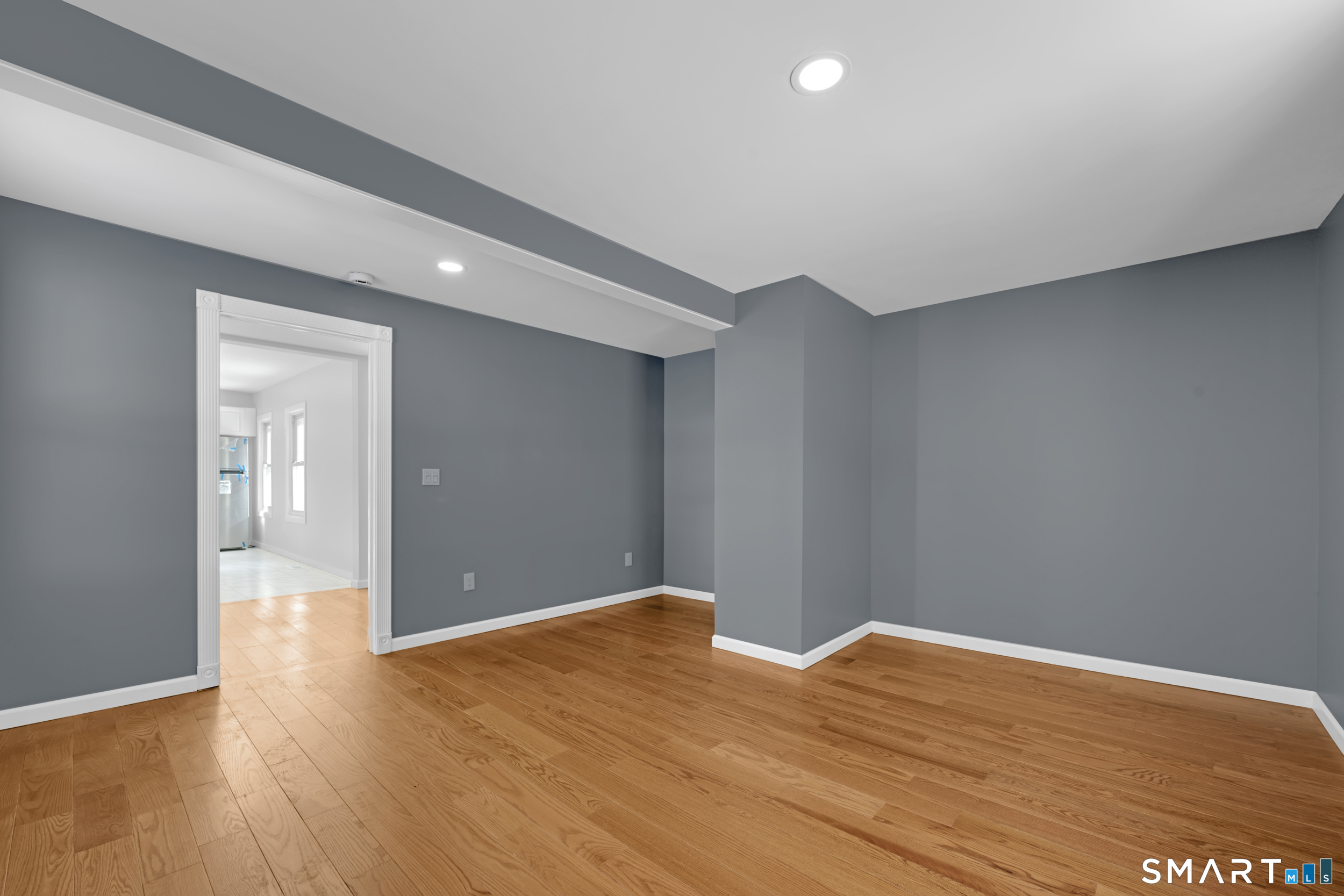 254 Broad Street Norwich, CT 06360 - Photo 12 of 38 a view of empty room with wooden floor