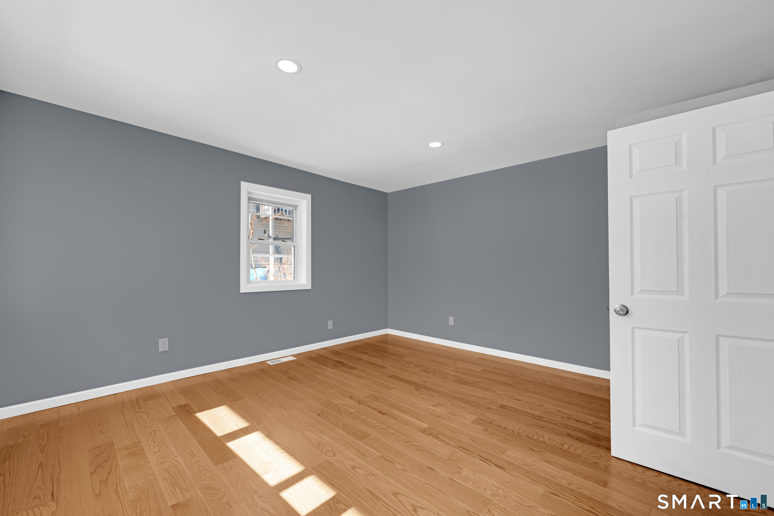 254 Broad Street Norwich, CT 06360 - Photo 14 of 38 a view of a big room with wooden floor and windows