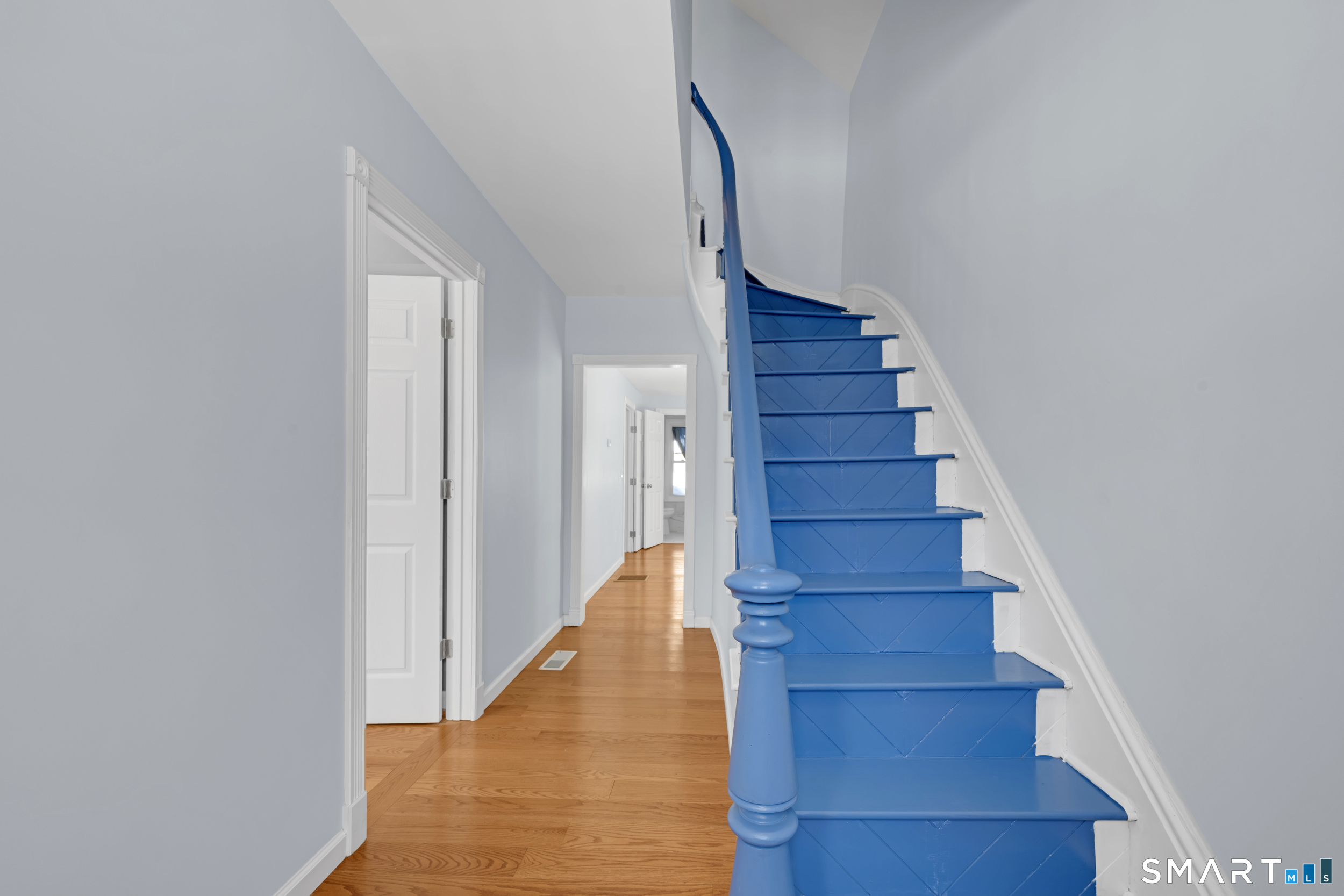 254 Broad Street Norwich, CT 06360 - Photo 17 of 38 a view of staircase with wooden floor and white walls
