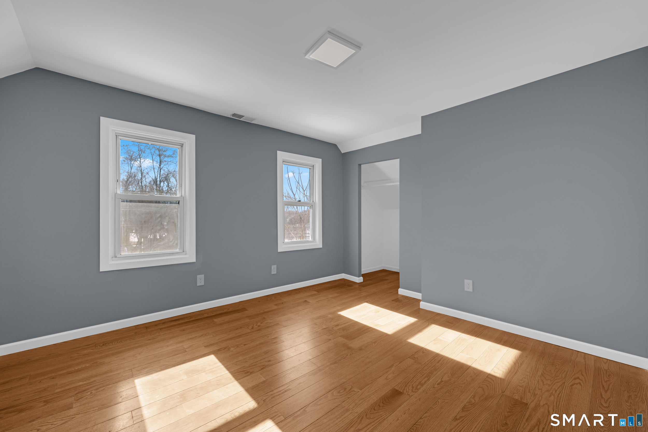 254 Broad Street Norwich, CT 06360 - Photo 18 of 38 a view of empty room with wooden floor and fan