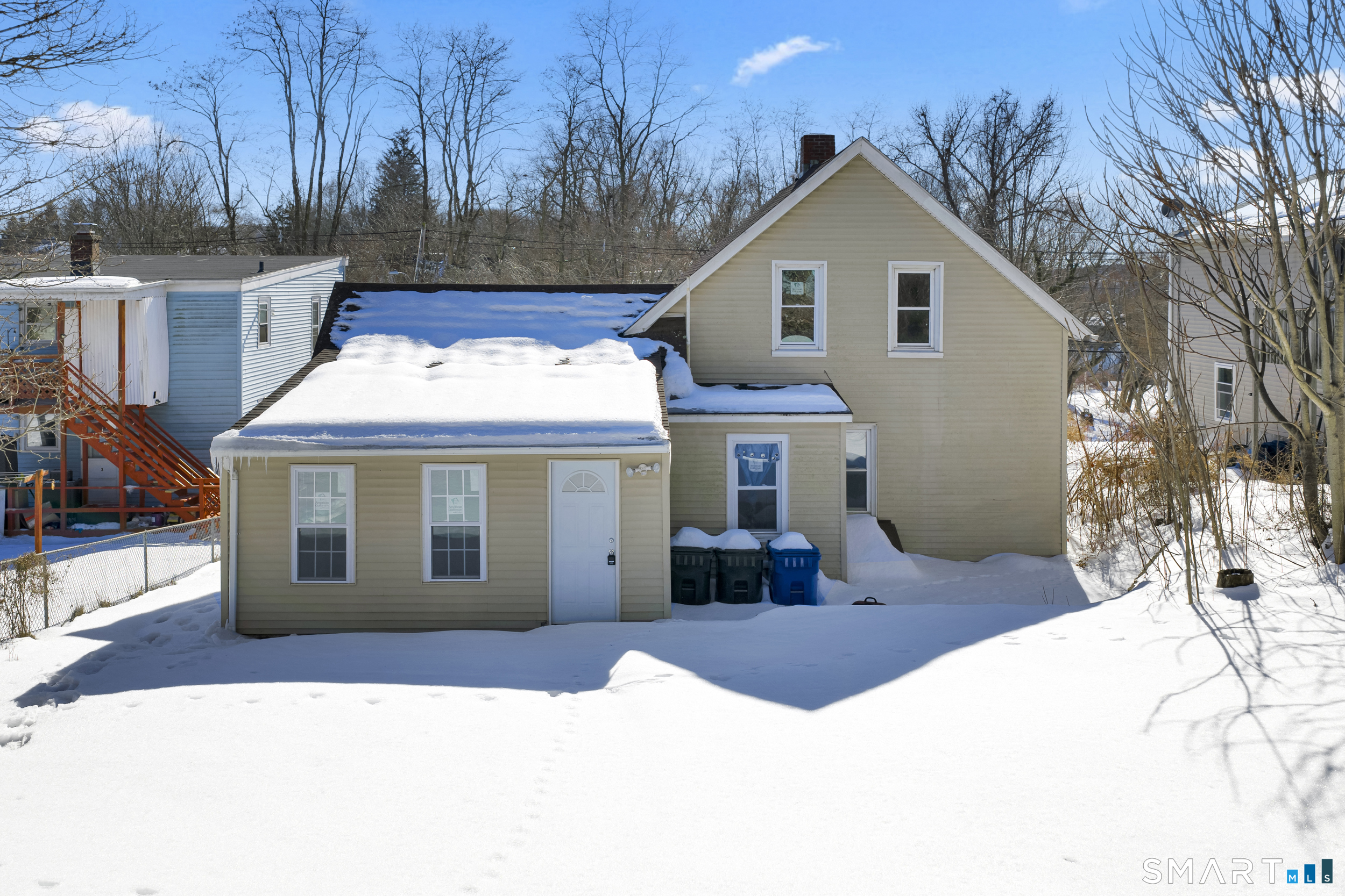 254 Broad Street Norwich, CT 06360 - Photo 31 of 38 a view of a white house with a yard and large tree