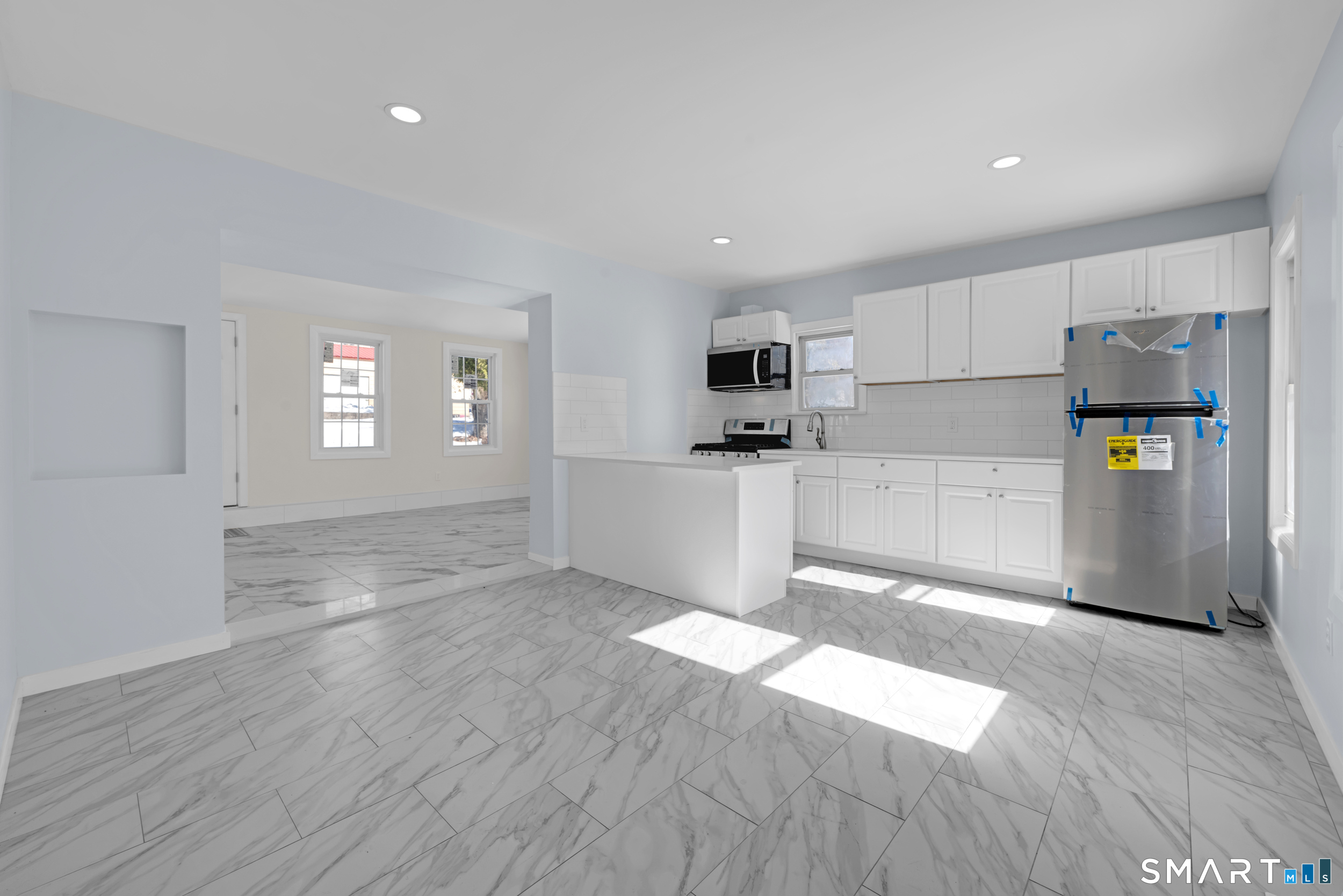 254 Broad Street Norwich, CT 06360 - Photo 5 of 38 a view of a kitchen with wooden floor and electronic appliances