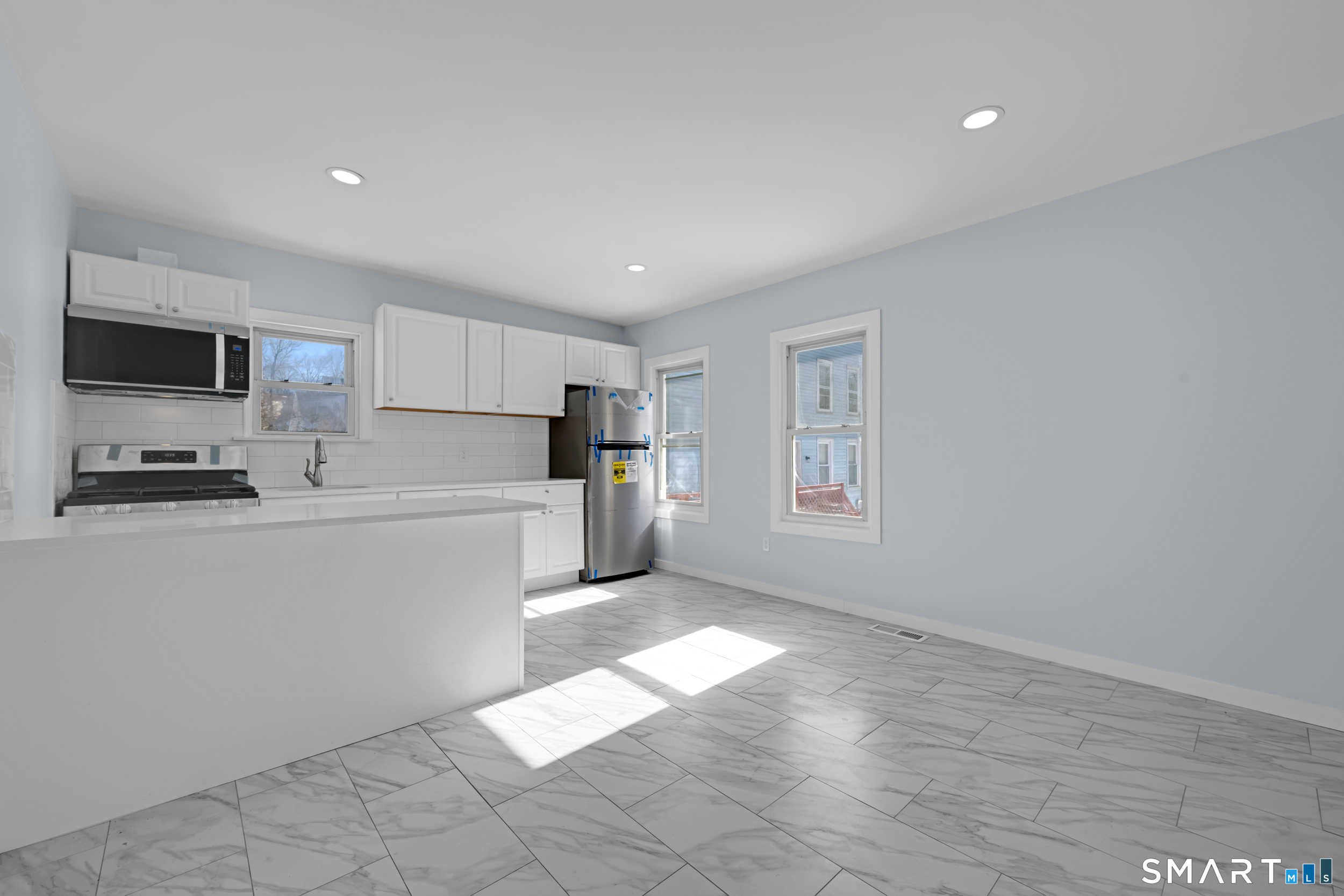 254 Broad Street Norwich, CT 06360 - Photo 6 of 38 a kitchen with a refrigerator and a stove top oven