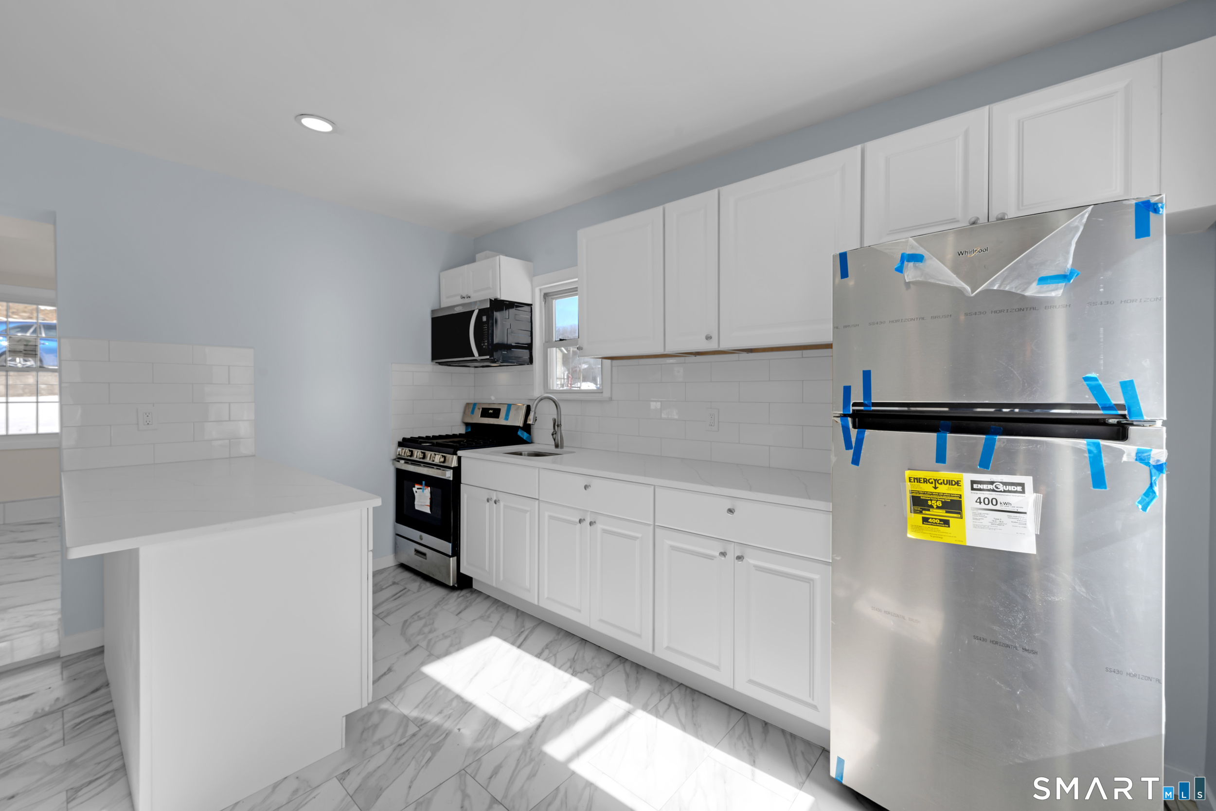 254 Broad Street Norwich, CT 06360 - Photo 7 of 38 a kitchen with a refrigerator and a stove top oven