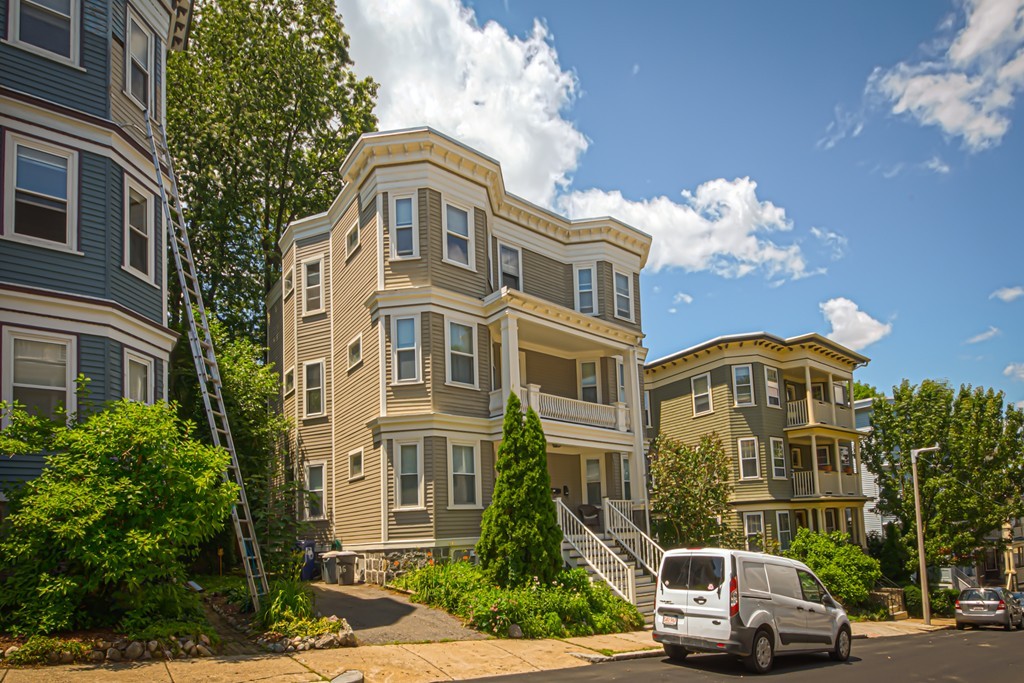 16 Parkton Road, Unit A Boston, MA 02130 - Photo 1 of 31 a front view of a residential apartment building with a yard