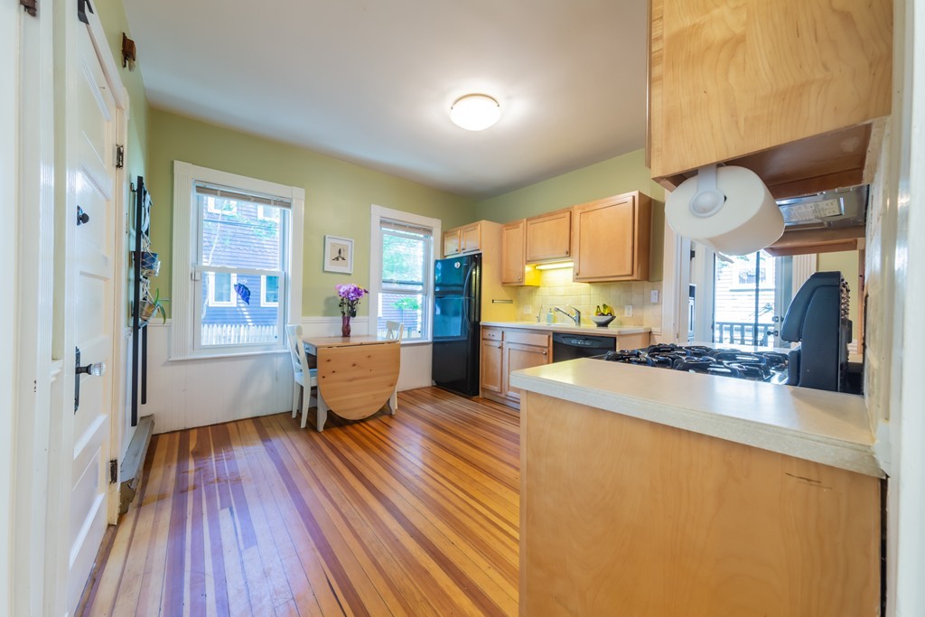 16 Parkton Road, Unit A Boston, MA 02130 - Photo 12 of 31 a large living room with stainless steel appliances granite countertop furniture a rug and a large window