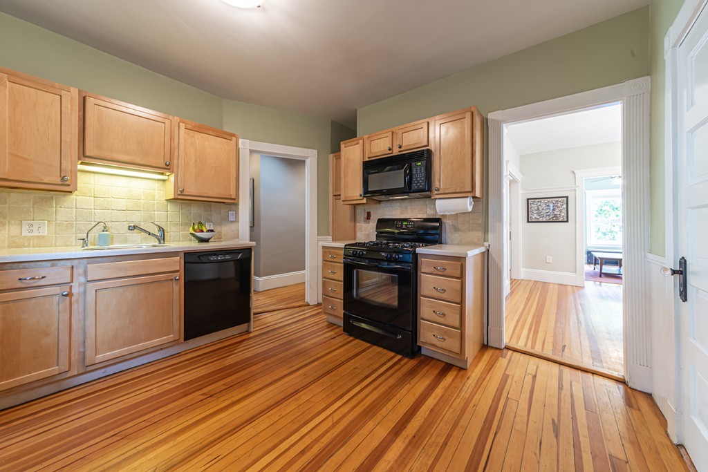 16 Parkton Road, Unit A Boston, MA 02130 - Photo 15 of 31 a kitchen with a sink wooden floor and stainless steel appliances