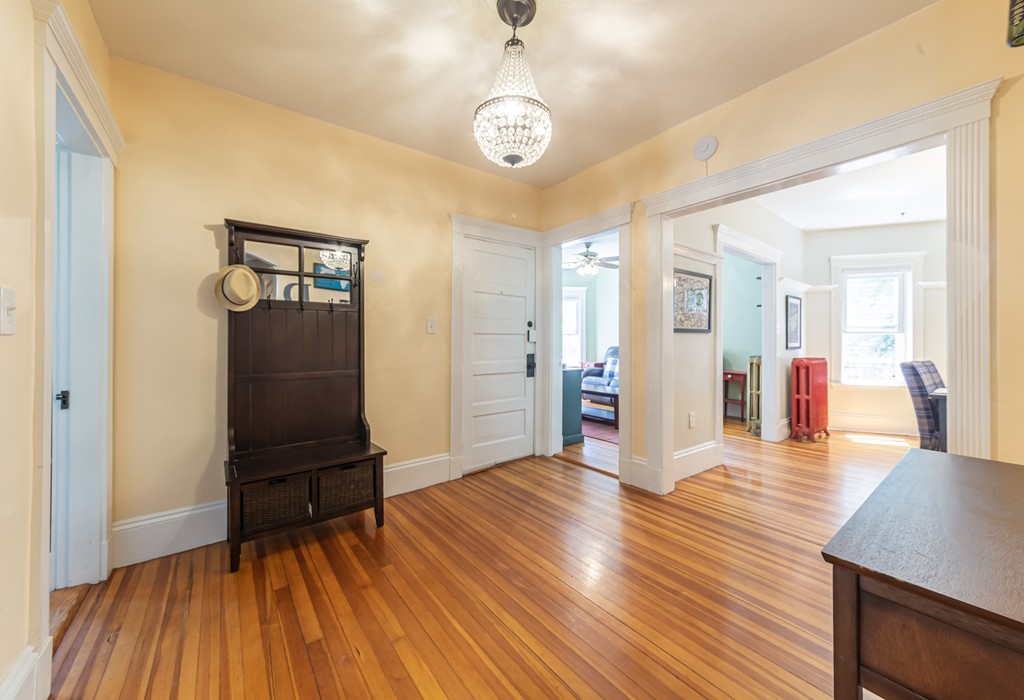 16 Parkton Road, Unit A Boston, MA 02130 - Photo 16 of 31 a view of a hallway with wooden floor and furniture