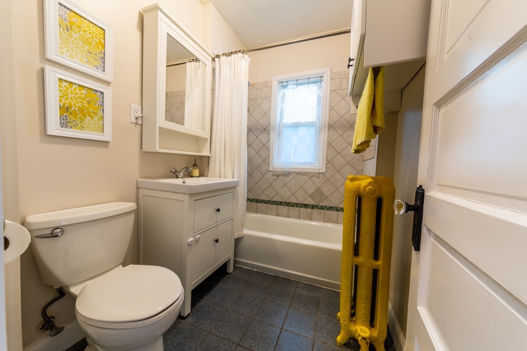 16 Parkton Road, Unit A Boston, MA 02130 - Photo 17 of 31 a bathroom with a toilet a sink and a bathtub