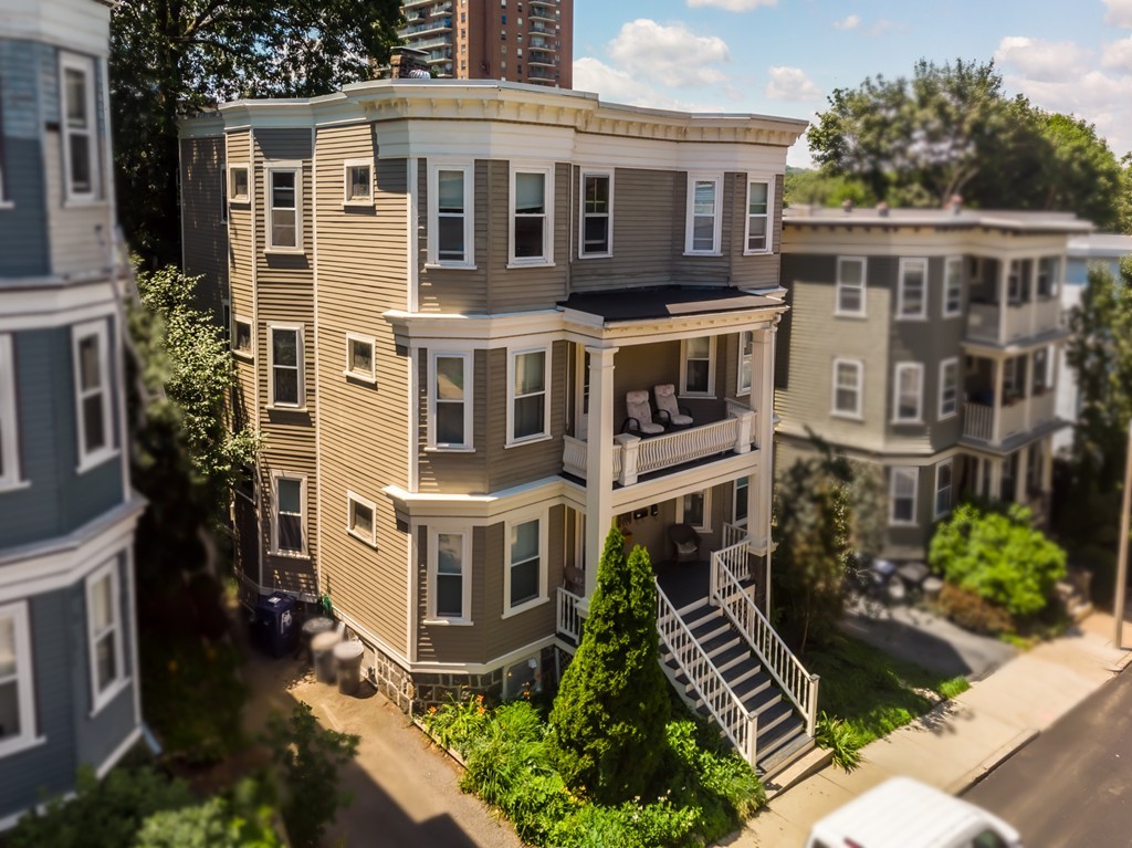 16 Parkton Road, Unit A Boston, MA 02130 - Photo 21 of 31 a aerial view of a house with a yard and potted plants