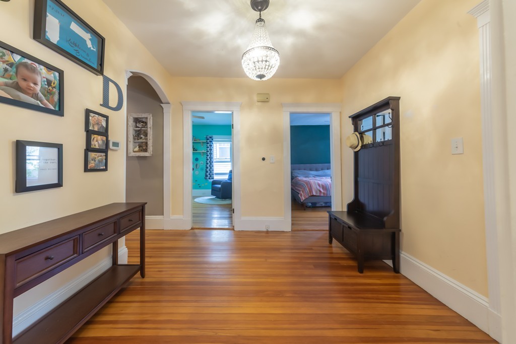 16 Parkton Road, Unit A Boston, MA 02130 - Photo 7 of 31 a view of a hallway with wooden floor and staircase