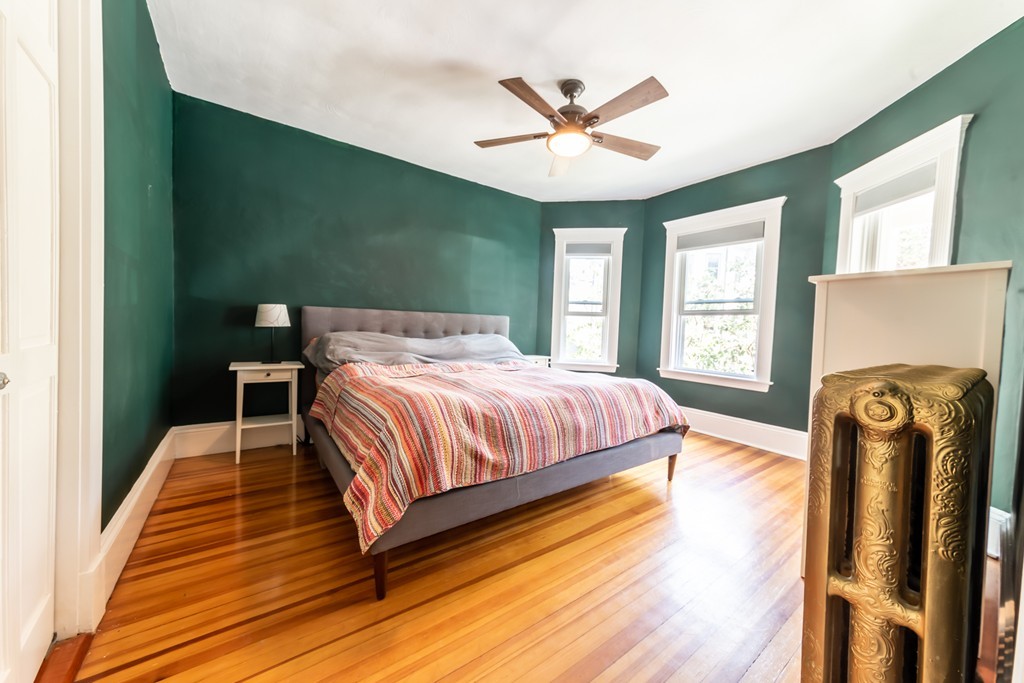 16 Parkton Road, Unit A Boston, MA 02130 - Photo 9 of 31 a bedroom with a bed and wooden floor