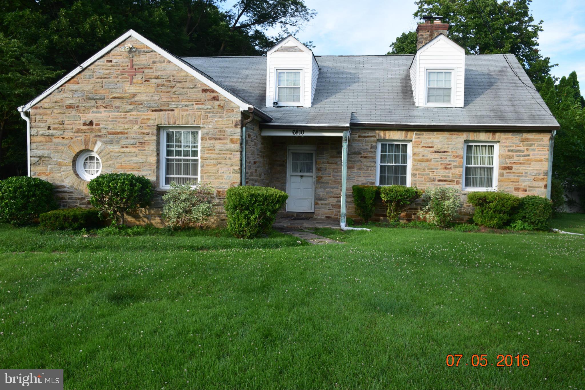 6810 Campfield Road Baltimore, MD 21207 - Photo 1 of 30 a front view of a house with a yard and garage