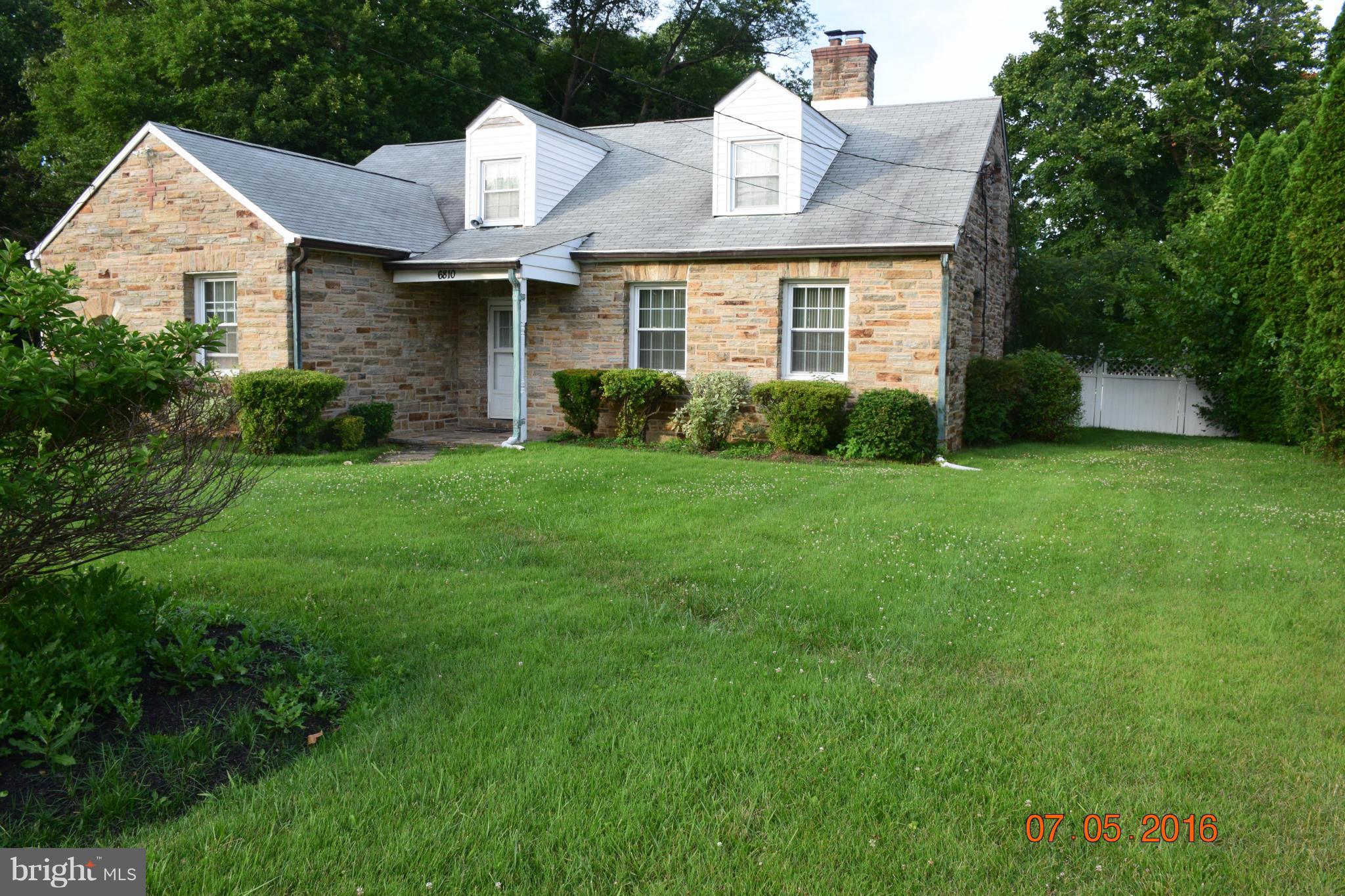 6810 Campfield Road Baltimore, MD 21207 - Photo 2 of 30 a front view of a house with a garden and yard