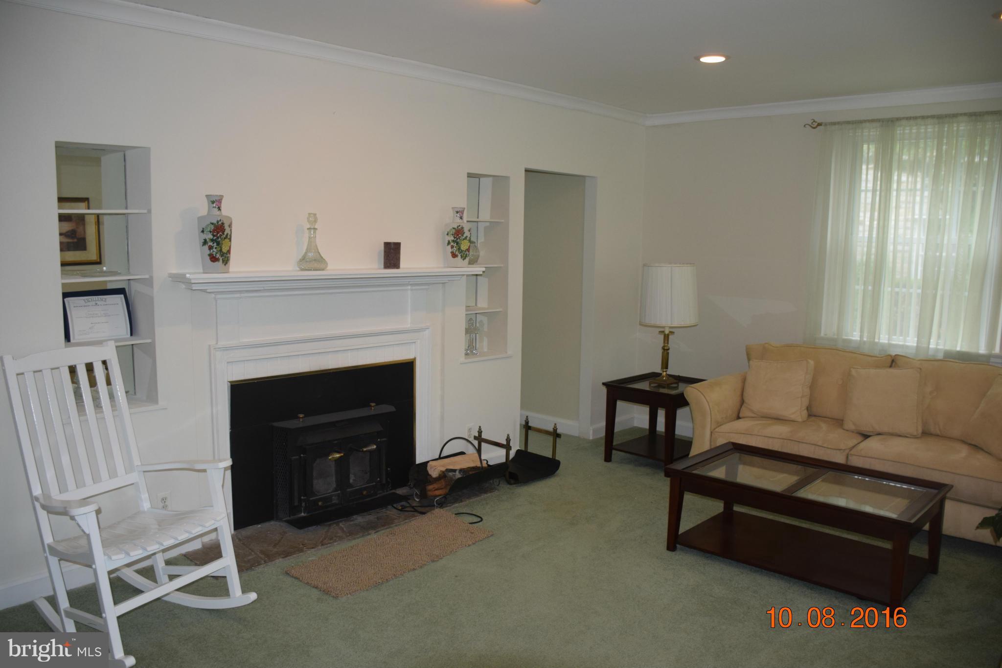 6810 Campfield Road Baltimore, MD 21207 - Photo 12 of 30 a living room with furniture and a fireplace