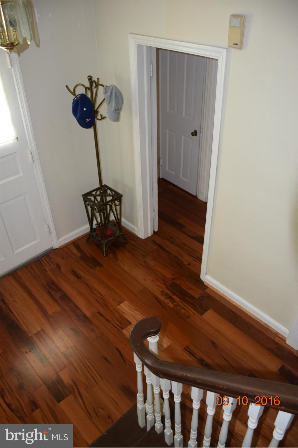6810 Campfield Road Baltimore, MD 21207 - Photo 17 of 30 a room with a wooden floor and a potted plant
