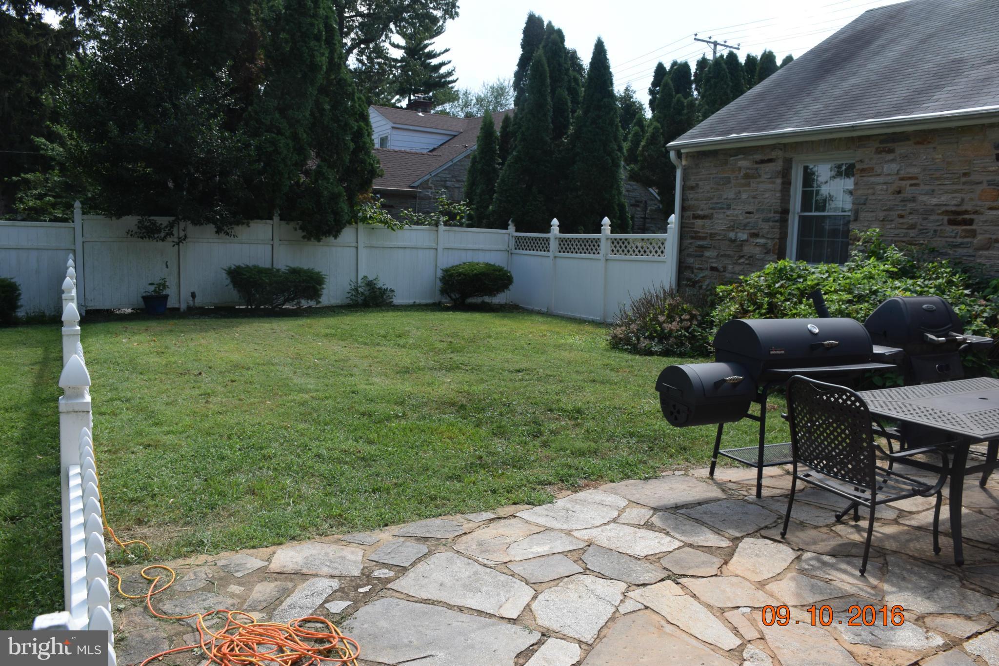 6810 Campfield Road Baltimore, MD 21207 - Photo 6 of 30 a backyard of a house with table and chairs plants