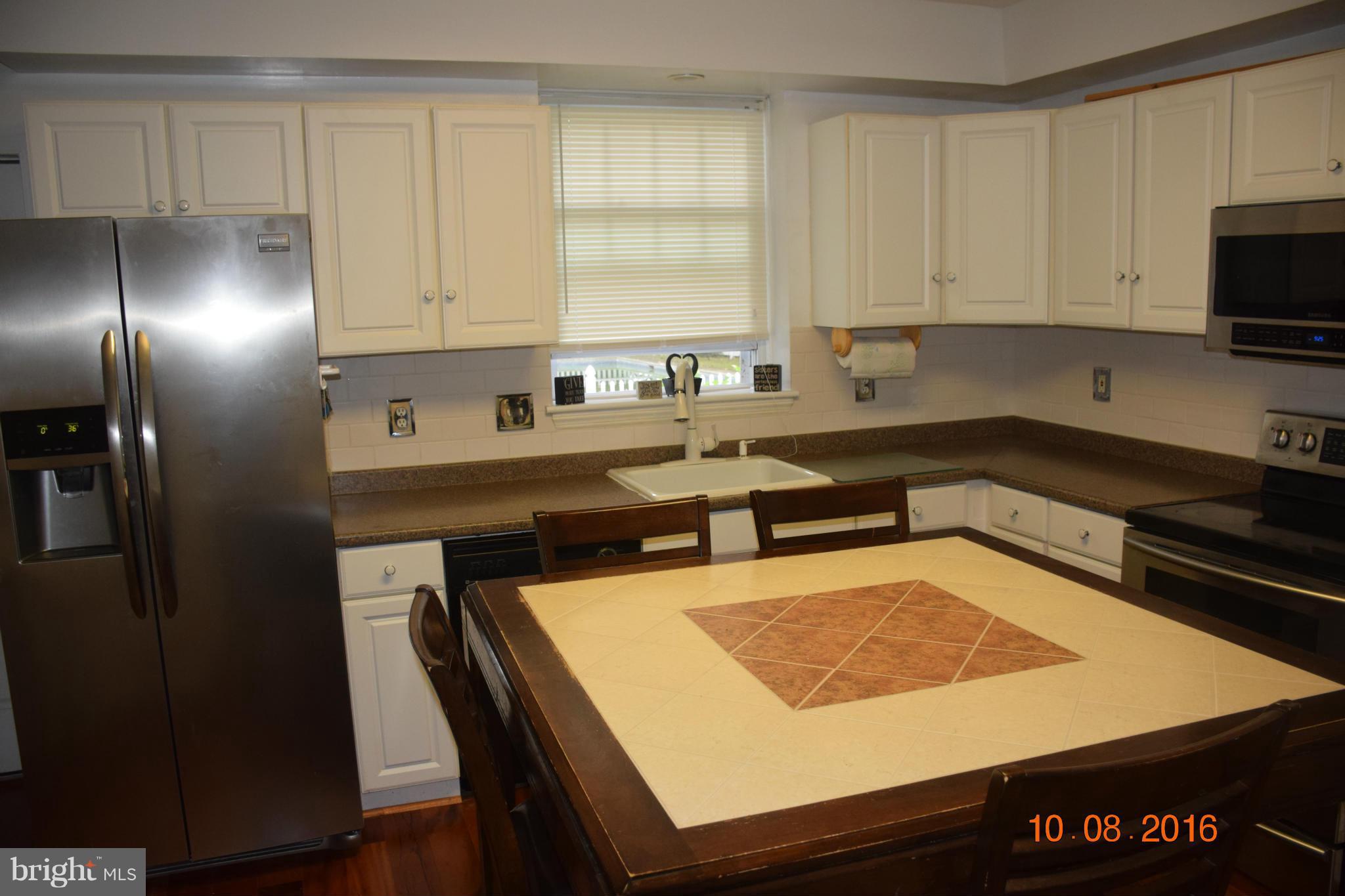 6810 Campfield Road Baltimore, MD 21207 - Photo 7 of 30 a kitchen with stainless steel appliances granite countertop a sink stove and refrigerator