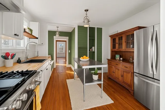 a kitchen with granite countertop a stove and a refrigerator