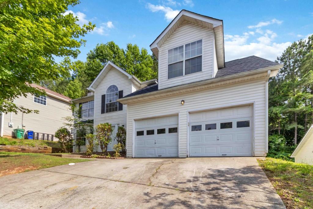 4783 Creekside Place Decatur, GA 30035 - Photo 2 of 24 a front view of a house with a yard and garage