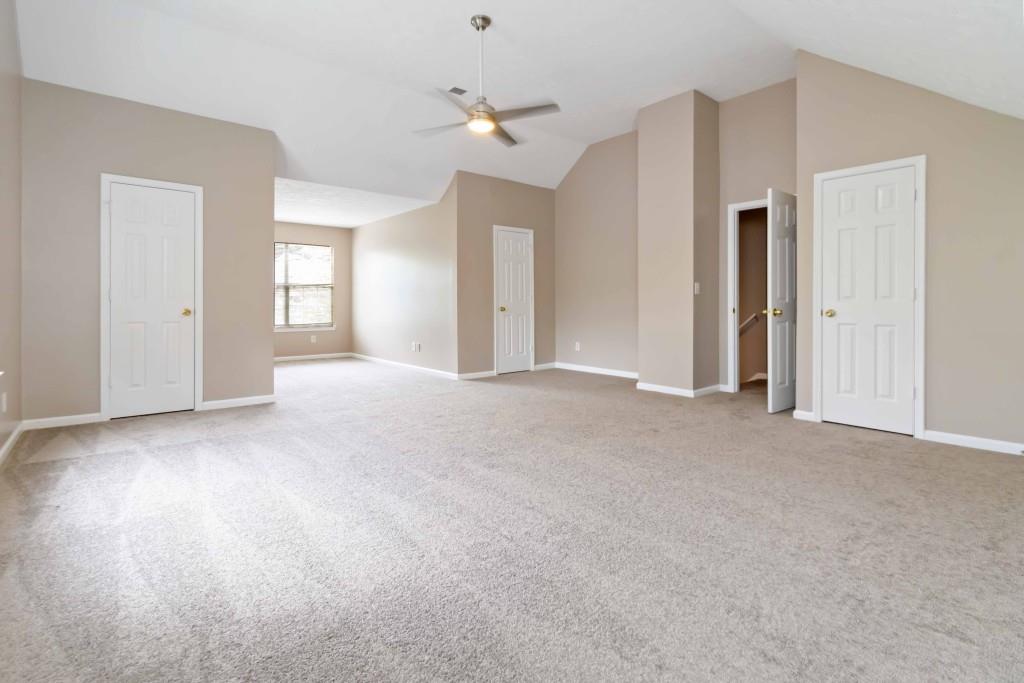 4783 Creekside Place Decatur, GA 30035 - Photo 21 of 24 a view of a big room with windows and chandelier fan