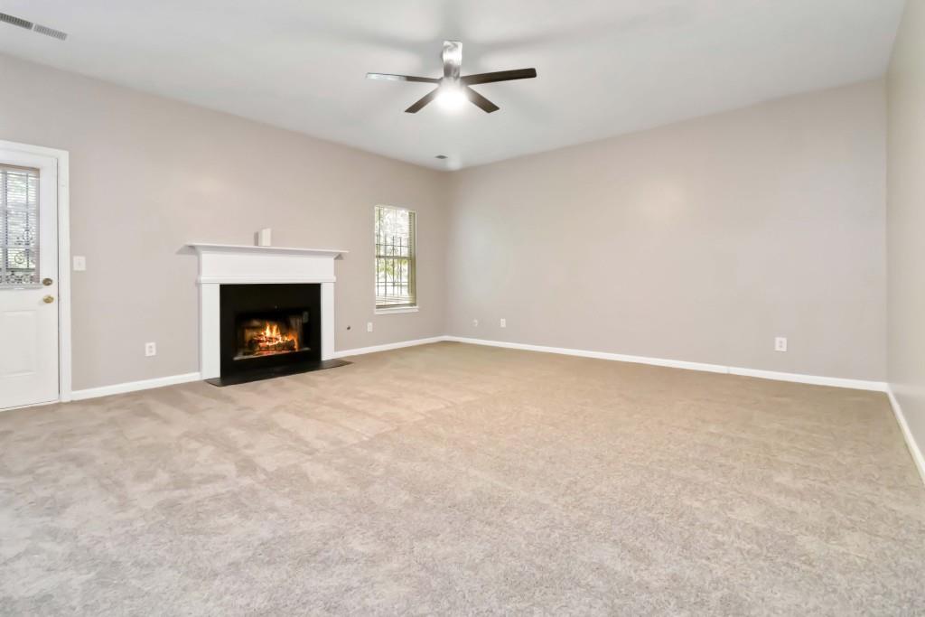 4783 Creekside Place Decatur, GA 30035 - Photo 4 of 24 an empty room with fireplace and fan