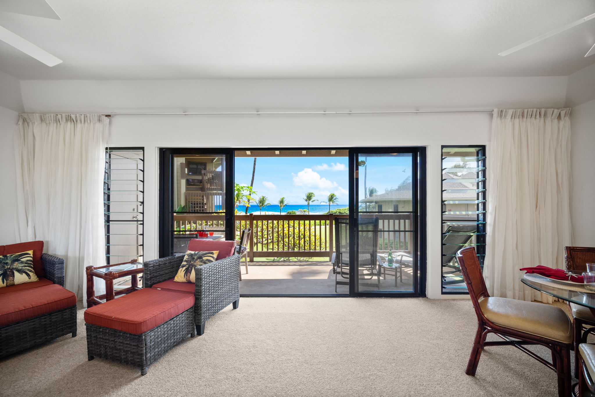 4460 Nehe Road, Unit 215 Lihue, HI 96766 - Photo 11 of 25 a living room with furniture and a floor to ceiling window