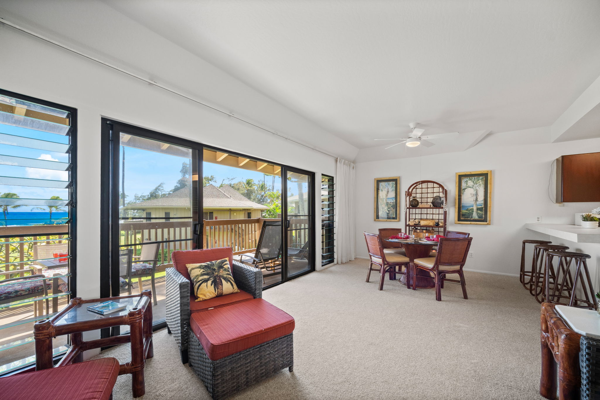 4460 Nehe Road, Unit 215 Lihue, HI 96766 - Photo 12 of 25 a living room with furniture and floor to ceiling windows