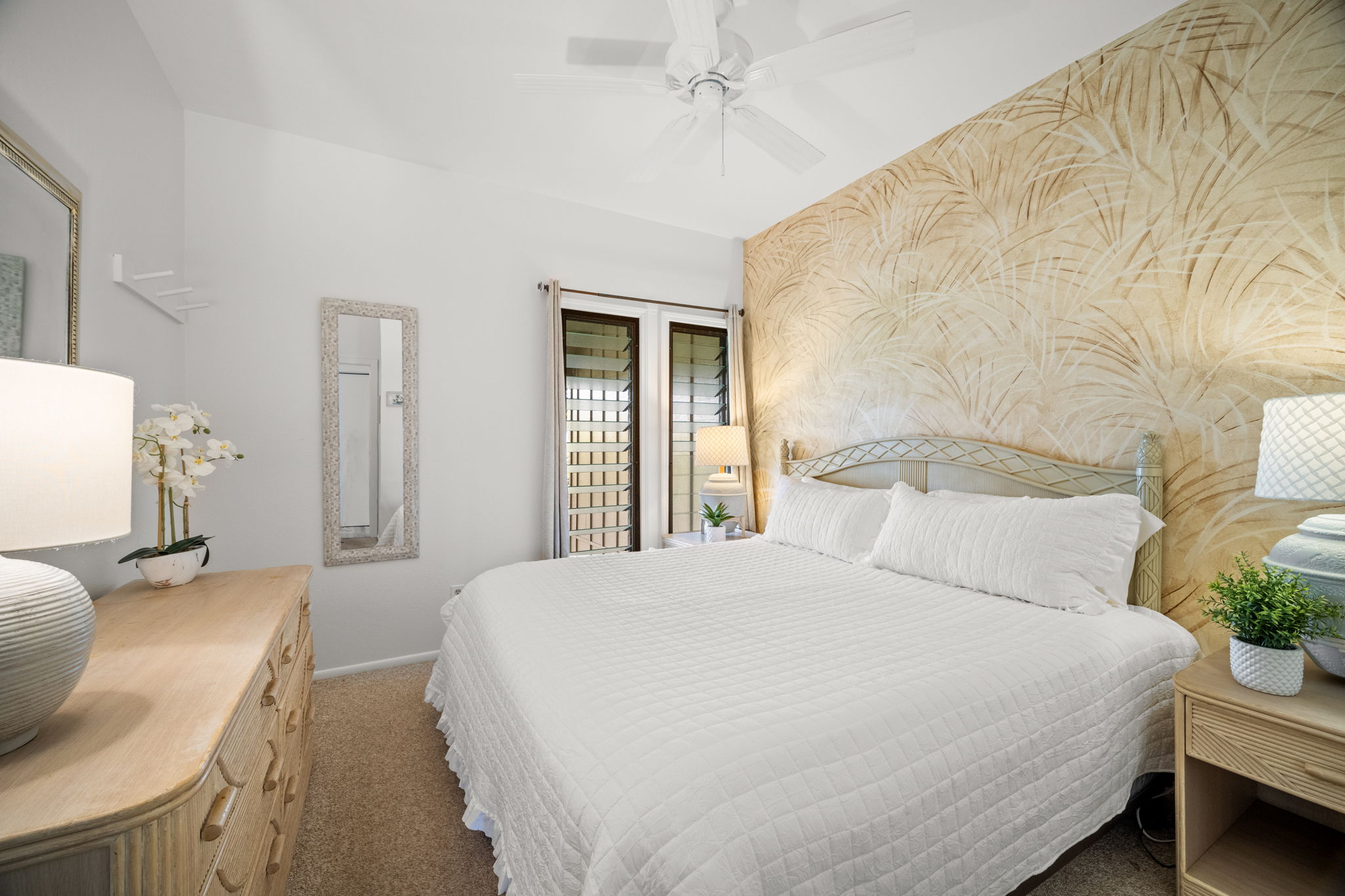 4460 Nehe Road, Unit 215 Lihue, HI 96766 - Photo 16 of 25 a bedroom with a bed and wooden floor