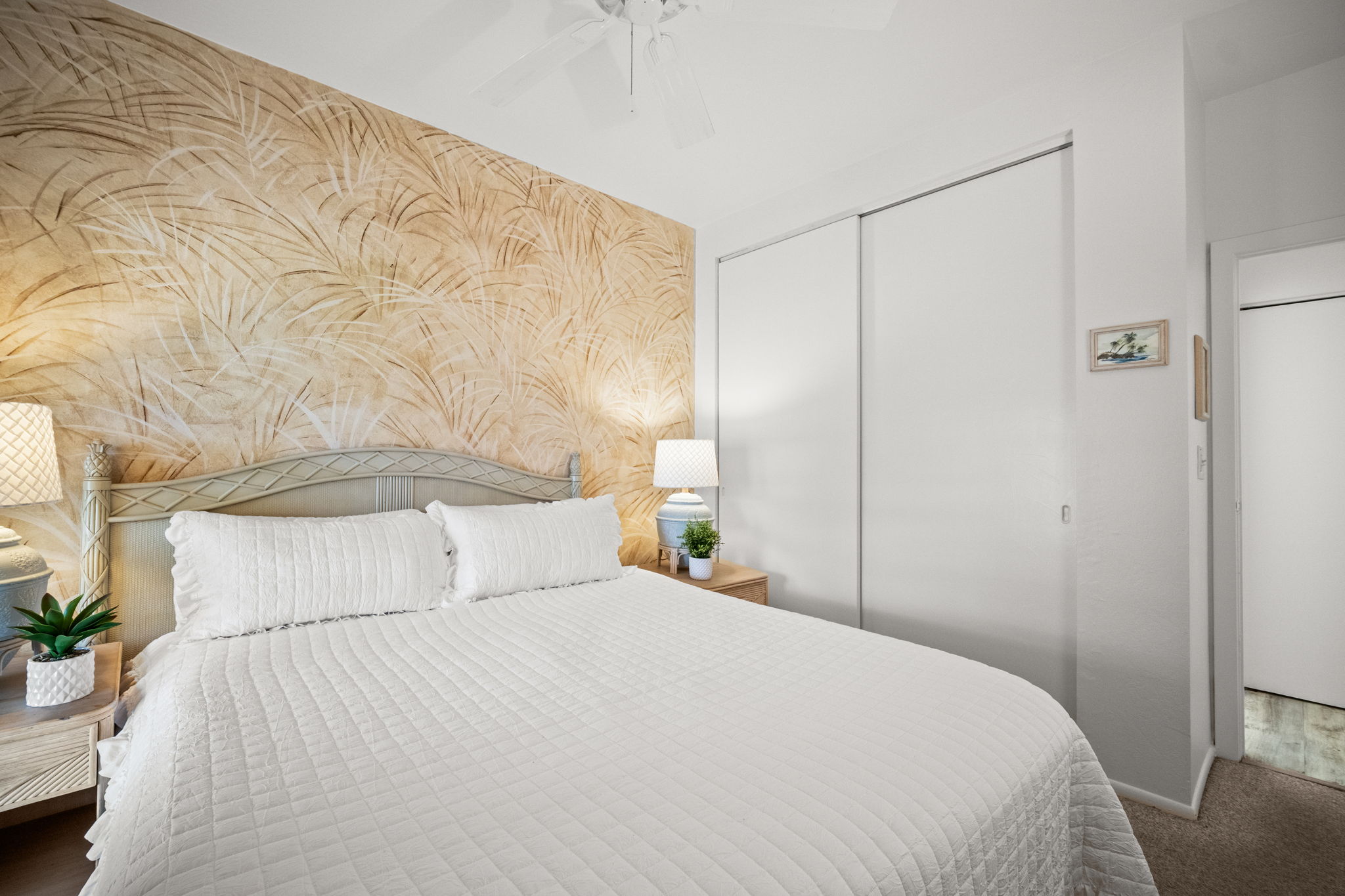 4460 Nehe Road, Unit 215 Lihue, HI 96766 - Photo 17 of 25 a bedroom with a bed and a potted plant