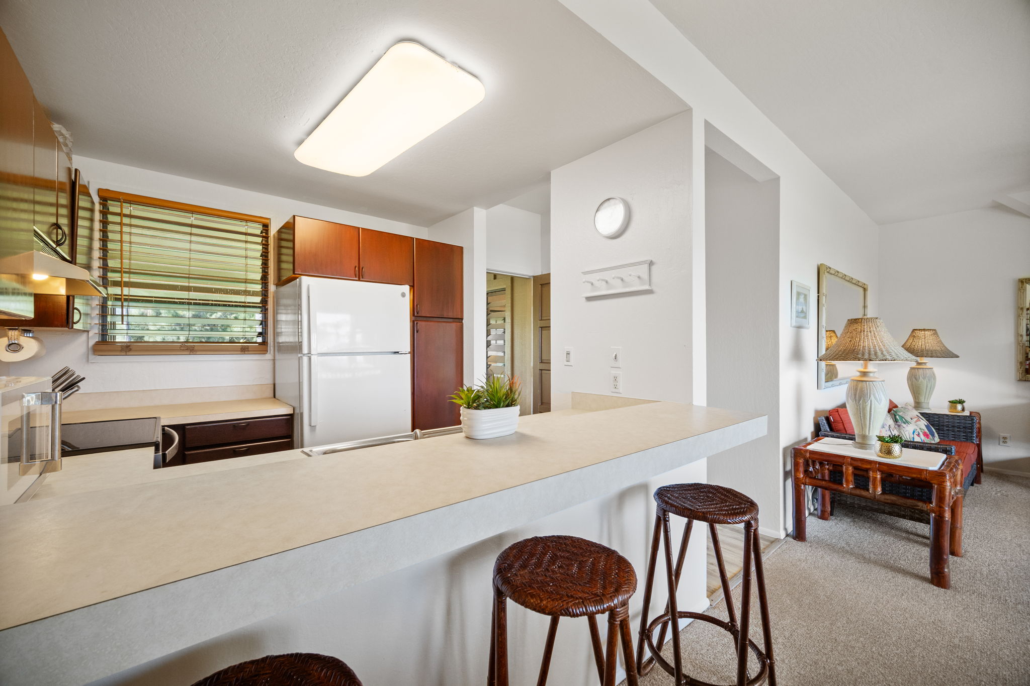 4460 Nehe Road, Unit 215 Lihue, HI 96766 - Photo 8 of 25 a living room with furniture and a large window