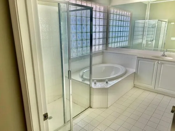 a bathroom with a bathtub and a shower