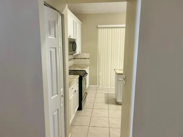 a kitchen with stainless steel appliances a sink a stove a microwave and cabinets