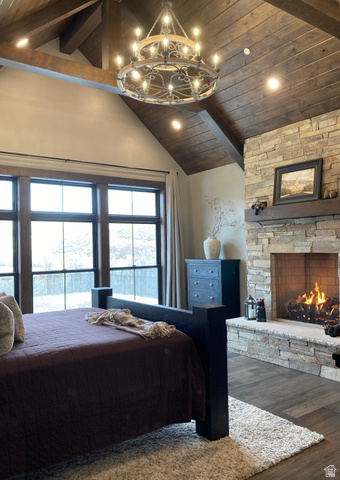259 Meadow Drive Springville, UT 84663 - Photo 18 of 62 Bedroom with a high wood beamed ceiling, dark wood-style flooring, a fireplace, and a chandelier