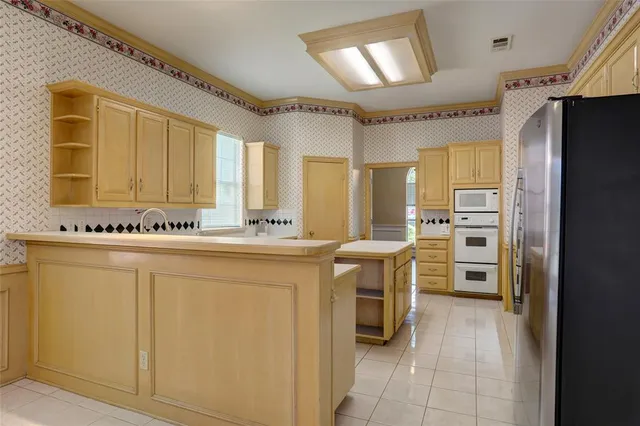a kitchen with stainless steel appliances a refrigerator and a stove