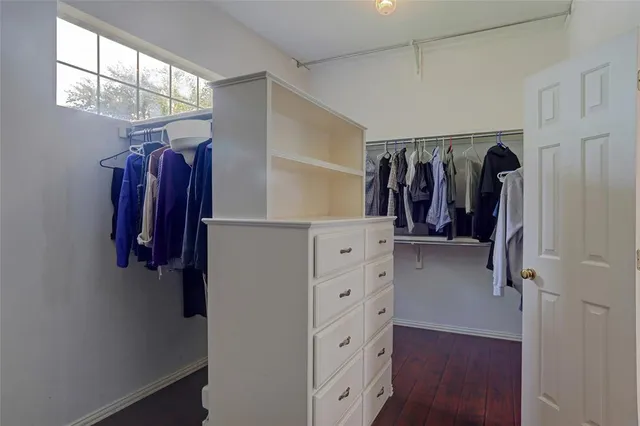 a view of walk in closet with clothes